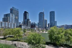 a tennis court in front of a city skyline at Lush Condo By CNTower - Free Parking in Toronto +11 photos