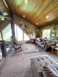 a living room with a couch and a table at Bear Lake Cabin with Lake Views in Fish Haven