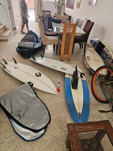a group of surfboards and a bag on the floor at Yellow House in Huanchaco