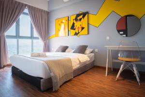 a bedroom with a large bed and a table at K Avenue by CAIRO in Donggongon