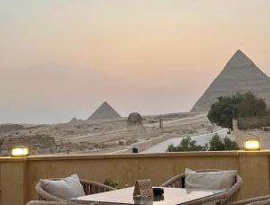 a view of the pyramids from the balcony of a restaurant at The Gate Hotel Pyramids in Cairo