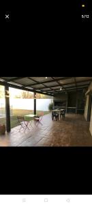 eine Terrasse mit zwei Picknicktischen und zwei Bänken in der Unterkunft Excelente casa, Ideal para Familia Fines de Semana in Cordoba