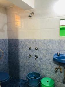 a bathroom with a blue toilet and a sink at Small Daddy Baga Beach in Baga