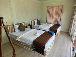 Postel nebo postele na pokoji v ubytování Naroth Beach Bungalow