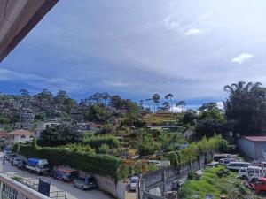 a view of a city with cars and trees at RAYAS Guesthouse- No Credit Card Needed in Baguio