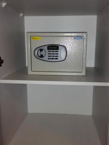 a microwave on a shelf in a refrigerator at New Arapey Hotel in Montevideo