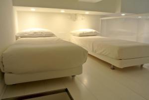 A bed or beds in a room at Duomo Inn