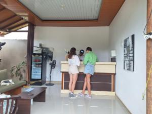 a man and a woman standing at a counter at Maliqa Villas Nusa Penida in Nusa Penida +28 photos