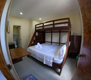 a bedroom with a bunk bed and a mirror at Angel Wish Guesthouse in El Nido
