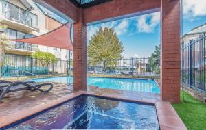 a swimming pool in front of a building at Warmful Apt in Subiaco w Free Parking in Perth