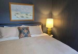 a bedroom with a bed with a pillow and a lamp at Moody Salem Home Away From Home in Salem
