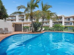 a large swimming pool in front of a building at Kawana Waters Ocean Front Unit- Sunshine Coast in Buddina