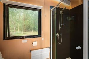 a bathroom with a shower with a window at Buffalo Plains Tiny House by Tiny Away in Buffalo