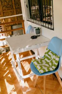 a white table and a chair with a pillow on it at Ozen Freediving Hostel in General Luna