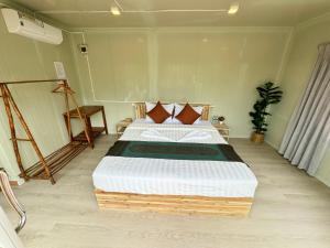a bedroom with a large bed in a room at Naroth Beach Bungalow in Koh Rong Island