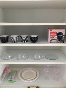 a shelf with plates and cups and wine glasses at sunset hills - Vacation STAY 21373v in Hamada