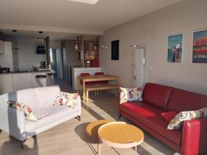 a living room with two couches and a kitchen at Appartement La Rochelle, 2 pièces, 2 personnes - FR-1-535-47 in La Rochelle