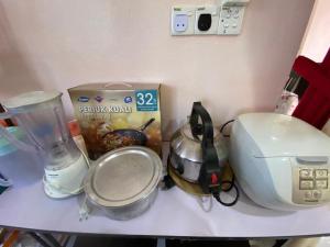 a counter top with a blender and a box on it at Surayahomestay in Bachok
