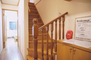 a staircase in a home with wooden floors at H2H VILLA鴫野西 三層公寓【JR京橋步行6分鐘】機場直達 容納6人3房1廳 自助入住 帶車位 in Osaka