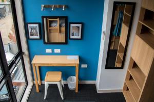a tiny house with a table and a stool at Adventure Q2 Hostel in Queenstown