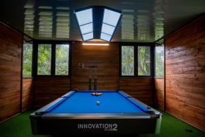a pool table in a room with a light at La Vie En Rose Ba Vì Homestay in Hanoi