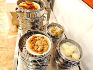 a bunch of food in canisters on a table at Guangzhou Ming Yue Hotel in Guangzhou