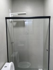 a glass shower in a bathroom with a toilet at Arambo Viagens e Hospedagens Loft 31 in Jaguarão +22 photos