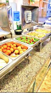 a buffet line with many different types of food at Guangzhou Ming Yue Hotel in Guangzhou