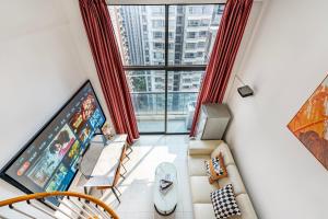 an overhead view of a living room with a large window at Meiru Apartment Hotel Guangzhou Bolin Apartment in Guangzhou