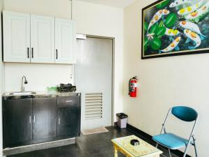 a kitchen with a sink and a chair in a room at Portal Residence in Jakarta