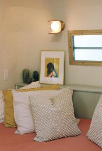 a bedroom with a bed with a picture and pillows at Dreamy Airstream Hideaway with Hot Tub in Gibsons