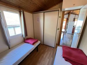 a small room with a bed and a window at Chalet Agde, 3 pièces, 6 personnes - FR-1-702-63 in Agde
