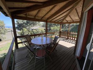 a patio with a table and chairs on a deck at Chalet Agde, 3 pièces, 6 personnes - FR-1-702-63 in Agde