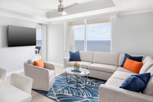 a living room with a couch and a tv at Sunseeker Resort Charlotte Harbor in Port Charlotte