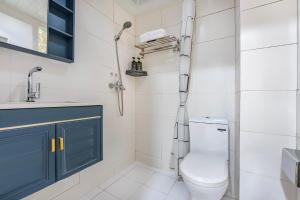 a bathroom with a toilet and a sink at Meiru Apartment Hotel Guangzhou Bolin Apartment in Guangzhou +40 photos
