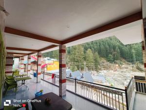 a view from the balcony of a ski resort at Chojh Inn Guest House in Kasol