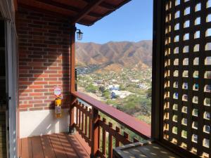 a balcony with a view of the mountains at Cabañas Annapurna in Taganga