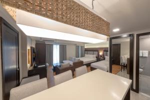 a kitchen and living room with a white table and chairs at Widus Hotel Clark in Clark