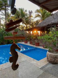 a resort with a swimming pool and a resort at Casa de Playa Barra Vieja Acapulco in Barra Vieja