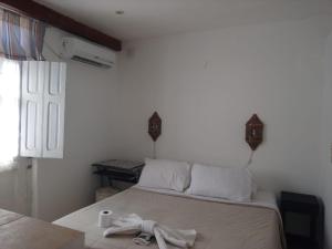 a bedroom with a bed with a towel on it at No me Olvides -Salta-somos mascoteros in Salta