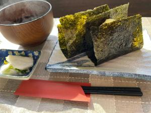 a plate of food and a bowl on a table at Ishiuchi Ski Center - Vacation STAY 09208v in Seki