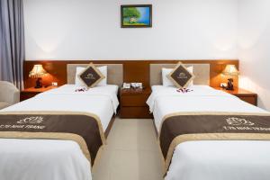 Postel nebo postele na pokoji v ubytování T78 Nha Trang Hotel