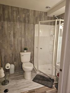 a bathroom with a toilet and a shower at Quad-Ks Cozy & Private Guest Suite in Halifax