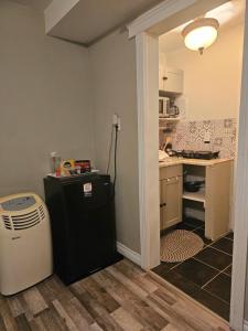 a kitchen with a small refrigerator and a counter at Quad-Ks Cozy & Private Guest Suite in Halifax