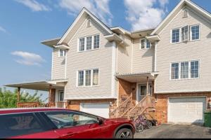 a red car parked in front of a house at Quad-Ks Cozy & Private Guest Suite in Halifax