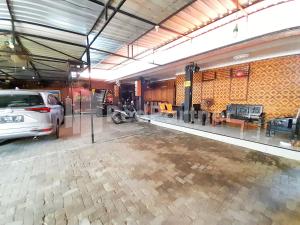 a parking lot with a car parked in a garage at LH101 Guest House Syariah near Makam Sunan Bonang RedPartner in Tuban