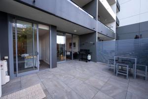 a patio with a table and chairs in a building at Eastside apartment in Charlestown