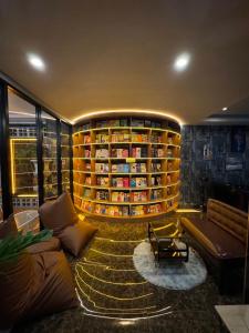 a living room with a large book shelf at The S Design Hotel in Buriram