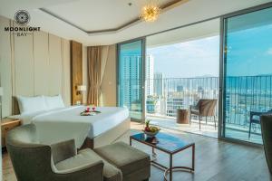 a hotel room with a bed and a large window at Moonlight Bay Panorama Ocean View in Nha Trang