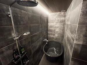 a bathroom with a sink and a shower at FUMAI sauna &INN-遠赤外線サウナ-松江の歴史と文化と共に過ごすsmart hotel in Matsue